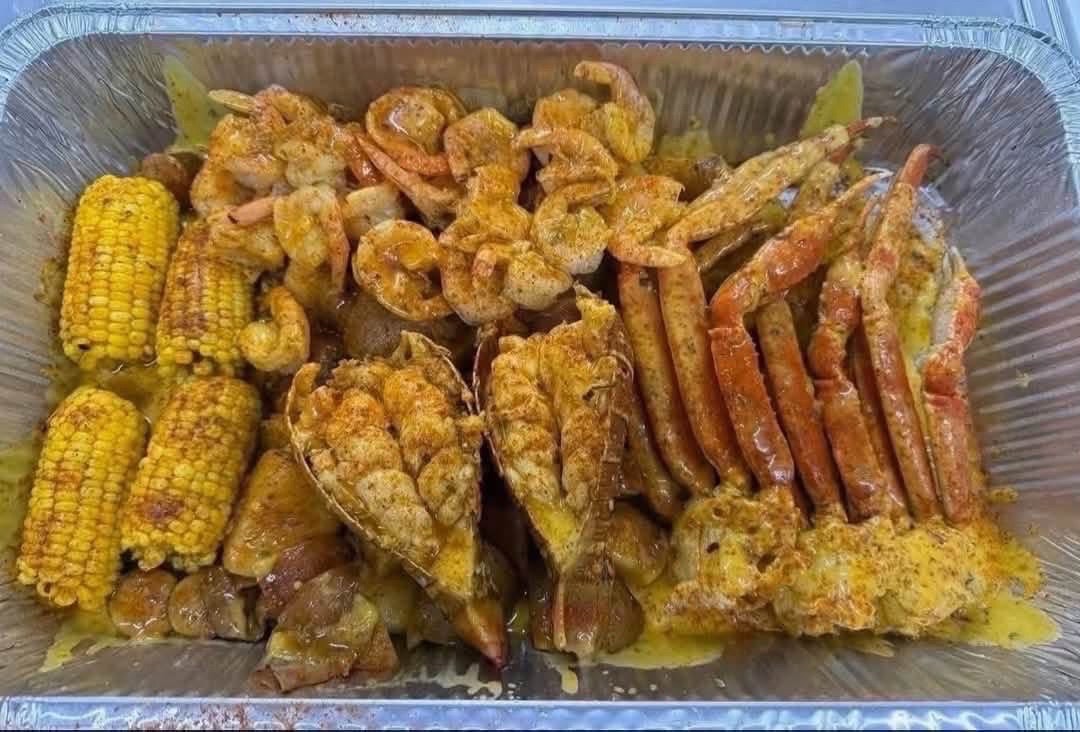 Seafood boil platter with shrimp, crab, and corn